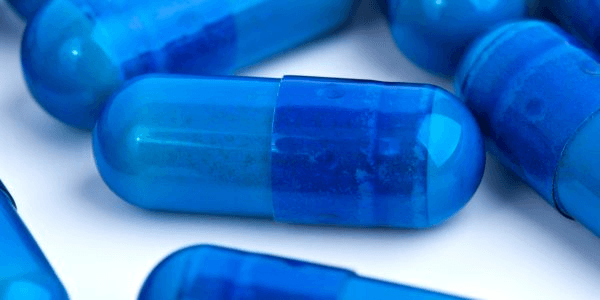A blue capsule representing the idea of Orlistat, a weight loss pill.