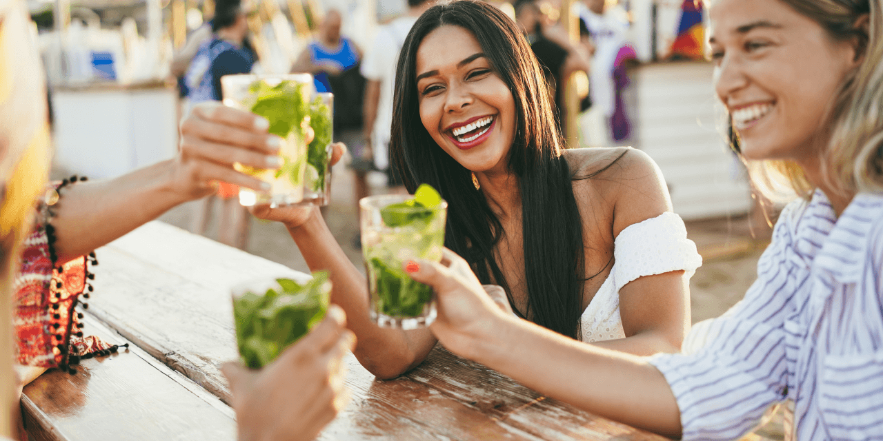 A group of friends drinking cocktails on a sunny day