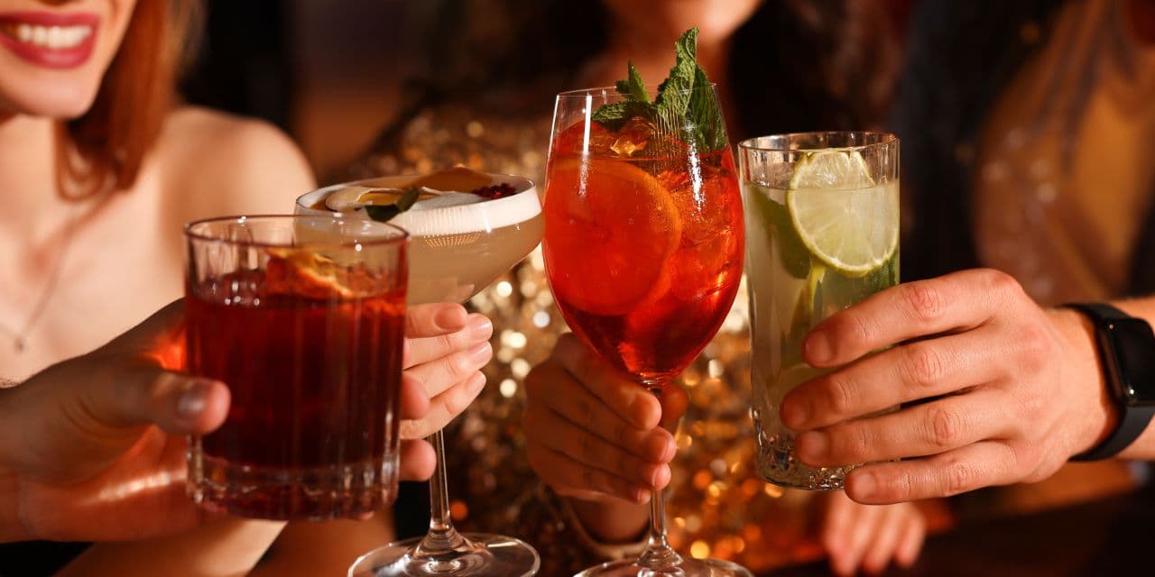 Close-up of cocktails as friends cheers on a night out