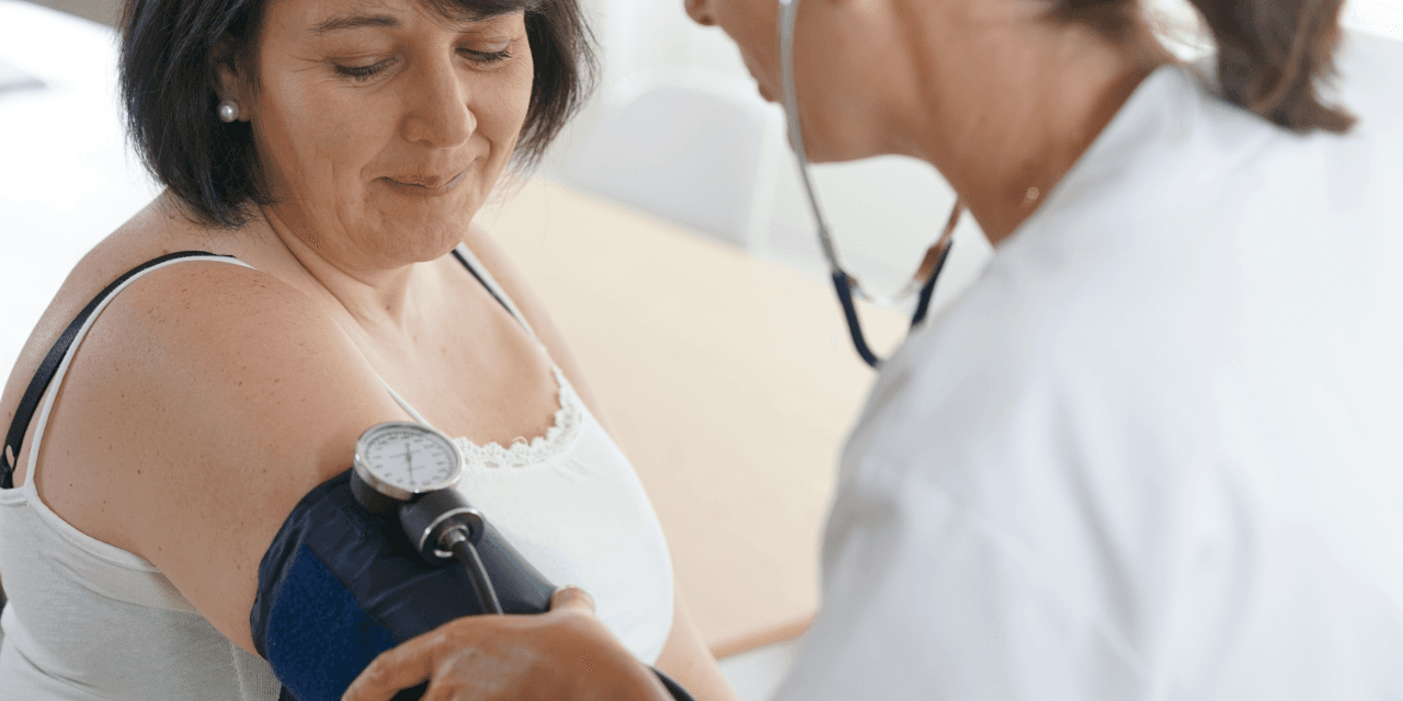Woman having her blood pressure checked by a doctor.