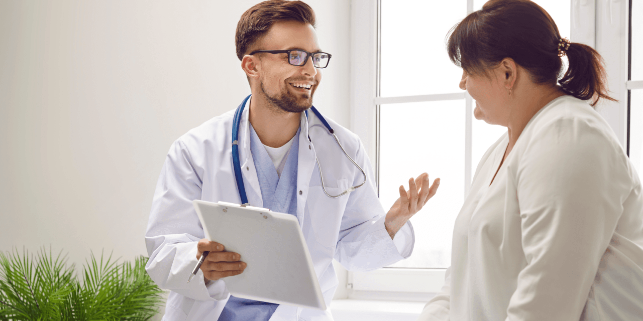 Young woman discussing with her GP