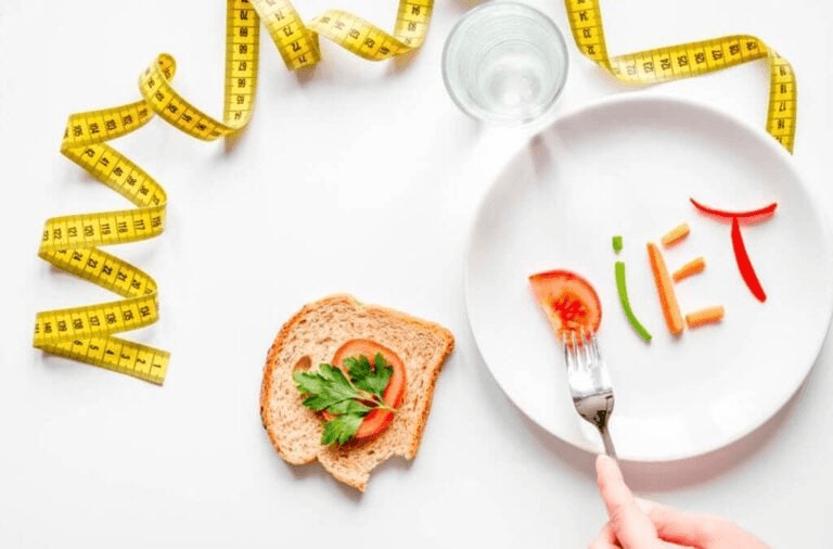 An image of the word diet spelt out in different vegetables, along with a tape measure. The greens alluding to fundamental parts of an effective diet for weight loss.