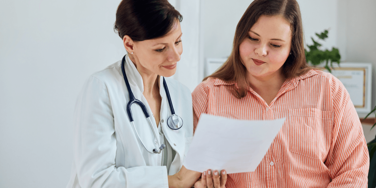 Young woman getting looking over a file with her clinician