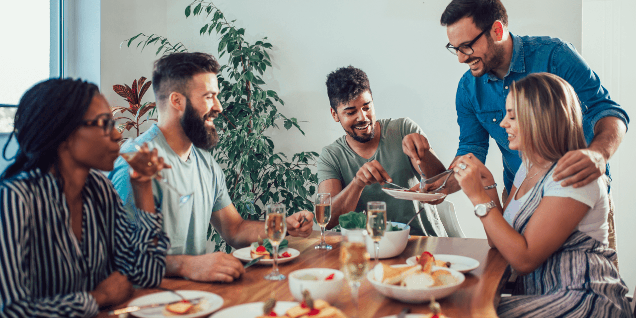 A group of friends enjoying food at a dinner party