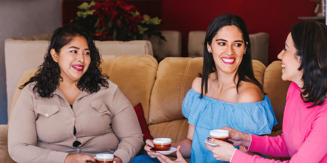 A group of female friends, chatting in a cozy cafe.