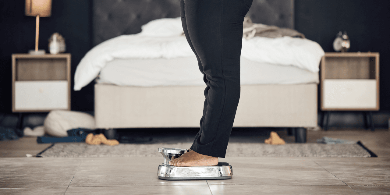 Woman weighting herself on a metal scale