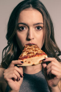 young lady eating pizza