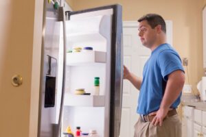 man checking out his refrigerator